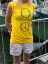 Greenpeace crew staff shows the logo on the t-shirt