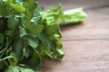 Greens in a bunch, parsley knitted elastic band on a wooden table