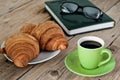 Greens cup of espresso coffee with croissants