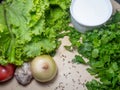 Greens for soup on the table. Greenery from the garden. Cutting board. Cooking. Vegan food. Useful product. Vegetable ingredients