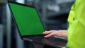 Greenscreen laptop closeup. Specialist hands typing computer on factory.