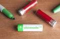 Greenwashing concept: some batteries and a green marker on a wooden table. Greenwashing is a communication technique aimed at Royalty Free Stock Photo