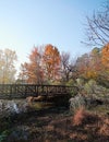 Greenway walking path bridge at Lake Raleigh with colorful Fall foliage Royalty Free Stock Photo