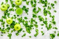 Greeny vegetable smoothie in glass with apple, celeriac on stone background top view mock up