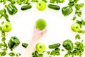 Greeny vegetable smoothie in glass with cucumber, pepper, apple, celeriac on white background top view mock up