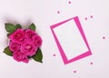 Greeteng card or other paper mock-up with pink roses and small paper hearts on the white background Royalty Free Stock Photo