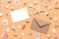 Greeting blank mockup card, brown envelope and seashells collection on pastel yellow background. Stationery still life in beach Royalty Free Stock Photo