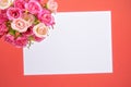 Greeting card bouquet of small roses with a white note, orange background. St. Valentine`s Day Royalty Free Stock Photo