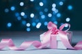 Greeting card for Christmas, New Year or wedding. White gift box or present with pink bow ribbon against magic bokeh background. Royalty Free Stock Photo