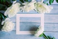 Greeting card with copy space for your text, beautiful large white peony flowers on vintage blue wooden background, top view, flat Royalty Free Stock Photo