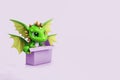 Greeting card with a cute dragon, the symbol of 2024 according to the Chinese horoscope on a lilac background.