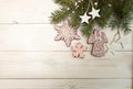 Greeting card with decor gingerbread cookies snowflakes, fir tree branch on white wooden background. Overhead of Christmas New Ye Royalty Free Stock Photo