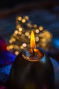 Greeting card Easter burning golden candle. Festive easter concept of candle and yellow eggs on a wooden table. Evening