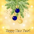 Greeting card with a fir branch with blue and gold Christmas balls