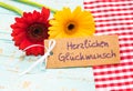 Greeting card with flowers and german text, Herzlichen Glueckwunsch, means congratulation