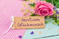Greeting card with german text, Herzlichen Glueckwunsch, means congratulation with bunch of flowers