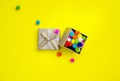 Greeting card. Gift box with multi-colored confetti on a yellow background. Happy birthday concept. Royalty Free Stock Photo