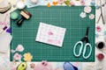 Greeting card on green cutting mat, scrapbooking tools and materials Royalty Free Stock Photo