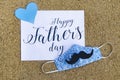 Greeting card Happy Father`s day decorated with facemask  in the context of coronavirus pandemic. Royalty Free Stock Photo