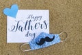 Greeting card Happy Father`s day decorated with facemask  in the context of coronavirus pandemic. Royalty Free Stock Photo