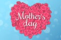 Greeting card for Happy Mother`s Day. Abstract blue lights bokeh. Inscription on a heart of pink realistic rose petals on a white Royalty Free Stock Photo