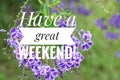 Greeting card - Have a great weekend. With beautiful purple flowers background. Nice weekend concept