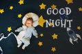 Greeting card with the inscription Good Night. Little boy baby sleeping on the background of the starry sky Royalty Free Stock Photo