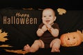 Greeting card with the inscription Happy Halloween. Happy baby boy with pumpkin Royalty Free Stock Photo