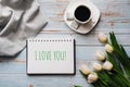 Greeting card with the inscription I Love You. Bouquet of white Tulip flowers with a Cup of coffee Royalty Free Stock Photo