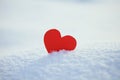 Greeting card with lonely heart on the dazzling blue snow