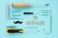 Greeting card. male tools, screwdrivers, wrenches, bolts, staples, screws, nuts, a shiny black mustache and an inscr Royalty Free Stock Photo