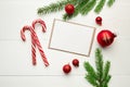 Greeting card mockup with candy canes  red christmas decorations and fir tree branches on white Royalty Free Stock Photo