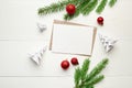 Greeting card mockup with christmas decorations and fir tree branches on white background Royalty Free Stock Photo