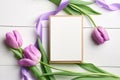 Greeting card mockup with envelope and tulip flowers bouquet with ribbon on white wooden background