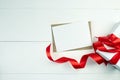 Greeting card mockup with paper envelope and red ribbon and gift box on white table Royalty Free Stock Photo