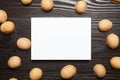 Greeting card mockup with walnut shells on wooden background, top view, flat lay. White blank holiday card on brown table Royalty Free Stock Photo