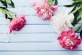 Greeting card for Mother or Woman day of beautiful pink and white peony flowers on blue vintage table from above in flat lay style Royalty Free Stock Photo