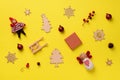 Greeting card for New year party. Christmas gifts, decorative elements and ornaments on yellow background. Top view, copy space. Royalty Free Stock Photo