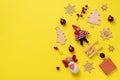 Greeting card for New year party. Christmas gifts, decorative elements and ornaments on yellow background. Top view, copy space. Royalty Free Stock Photo