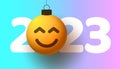 Greeting card for 2023 new year with smiling emoji face that hangs on thread like a christmas toy, ball or bauble. New year Royalty Free Stock Photo