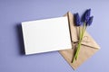 Greeting card stationary mockup with envelope and spring blue muscari flowers Royalty Free Stock Photo