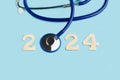 2024 greeting card with an stethoscope in the shape of cero on a blue background