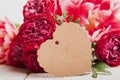 Greeting card with tag and red roses close-up. International Women's Day, Mother's Day, March 8 concept Royalty Free Stock Photo