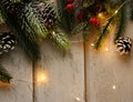 Greeting card template with fir tree twigs  pine cones  and vivid red berries on the wooden background Royalty Free Stock Photo