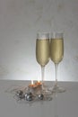 Greeting card template made of two glasses of champagne with two candles, silver christmas balls and string of beads with copy spa