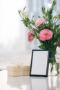 A greeting card template with a place for text, a photo of a blank frame in a bouquet of lisianthus flowers