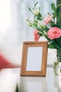 A greeting card template with a place for text, a photo of a blank frame in a bouquet of lisianthus flowers