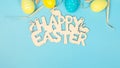 greeting card with text happy easter. multicolored easter eggs on blue background