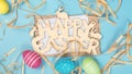 greeting card with text happy easter. multicolored easter eggs on blue background