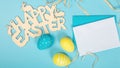 greeting card with text happy easter. multicolored easter eggs on blue background